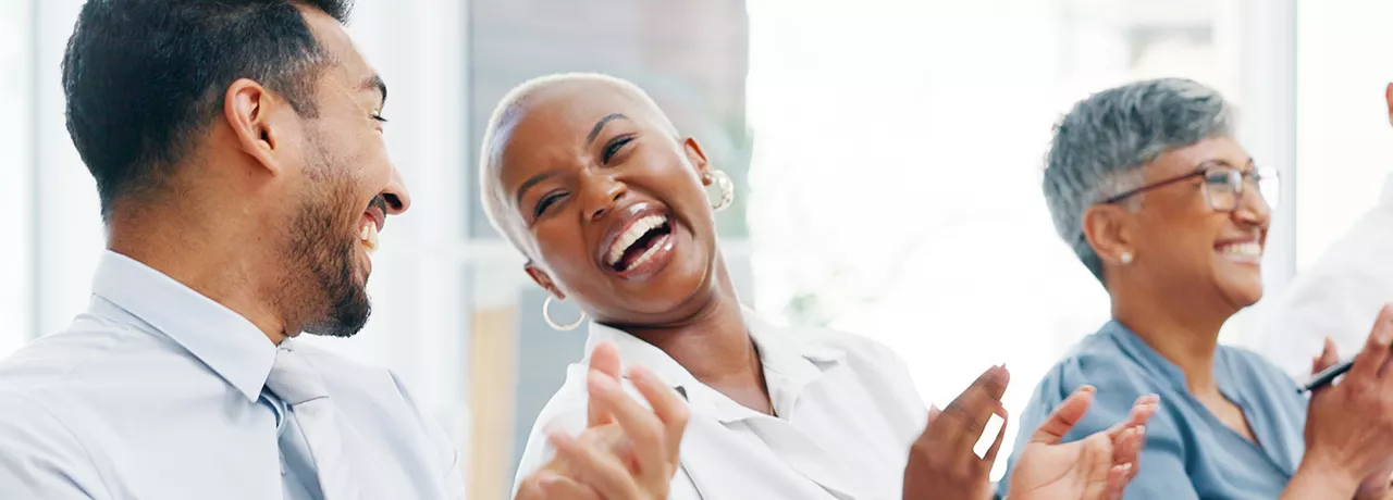 Group of happy employees clapping