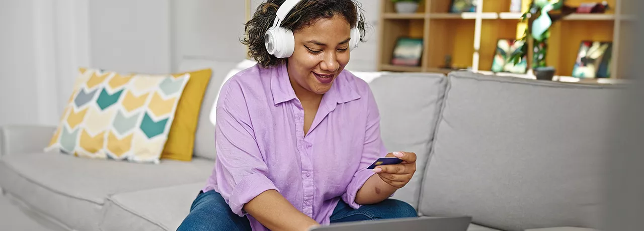 woman wearing headphones and shopping online
