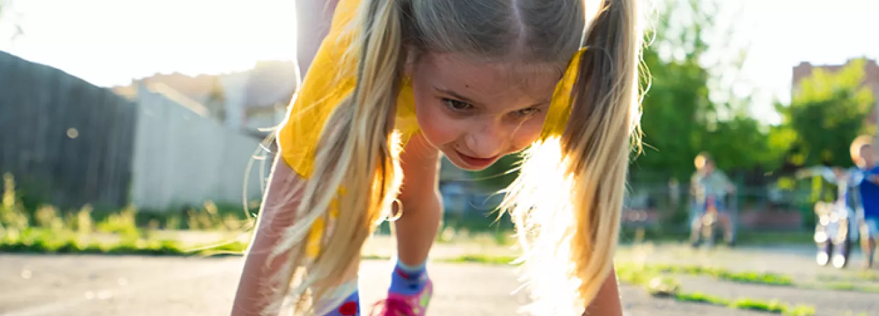 Young girl about to start a running race