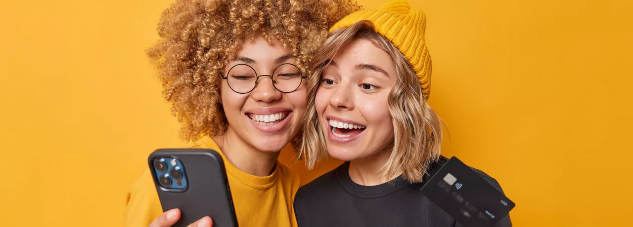 Happy and smiling women holding phone