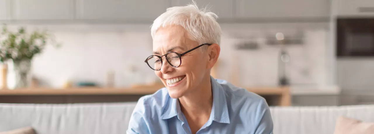 Happy older lady saving some money