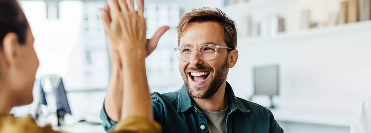 Happy employees giving each other a high five
