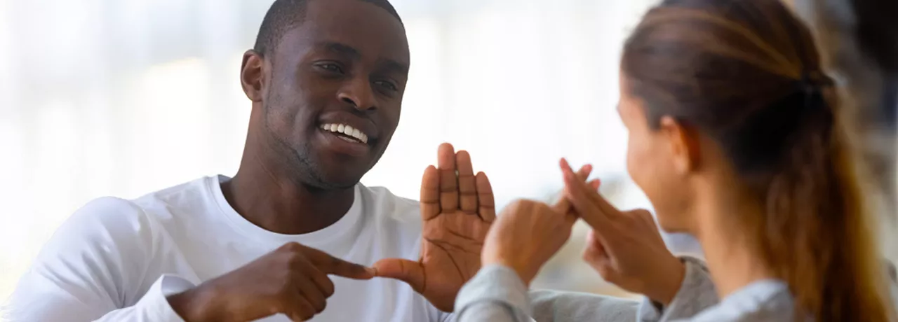D/deaf man and woman communicating via sign language