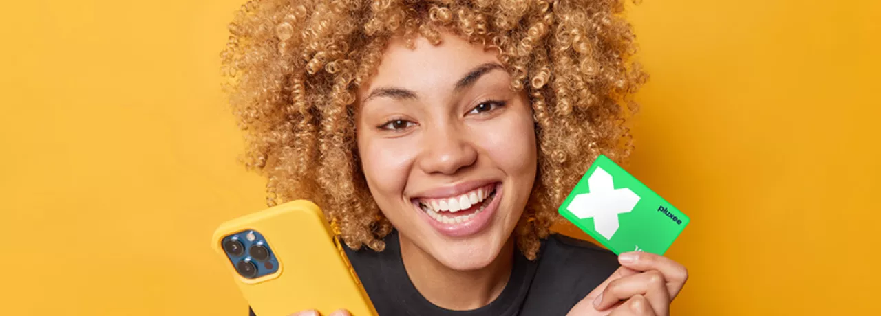 lady smiling and holding her Pluxee Card