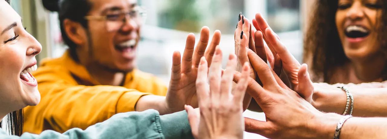 Group of people giving each other a high five