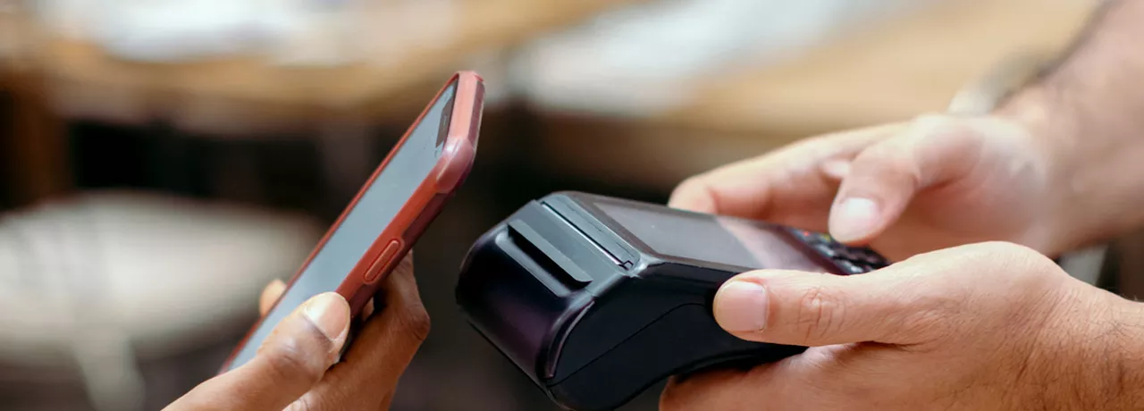 Person contactless paying using their phone
