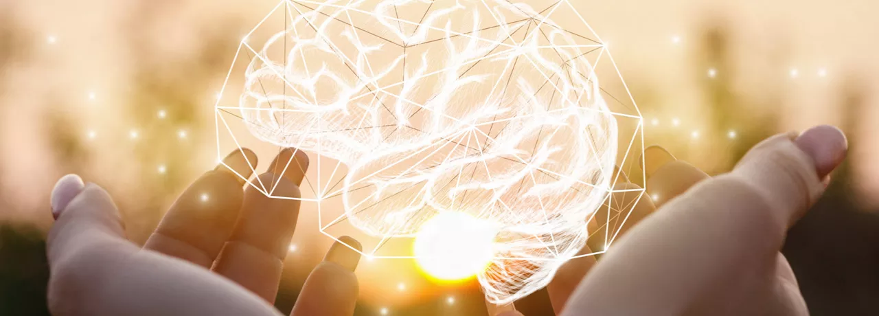 Holding an image of a brain made of lights