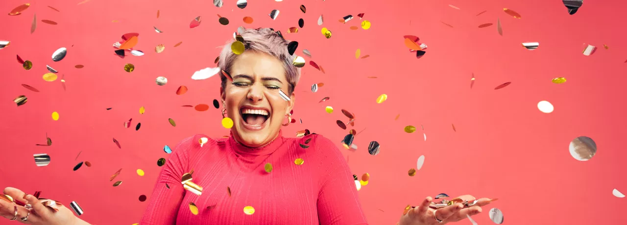 woman celebrating with glitter confetti