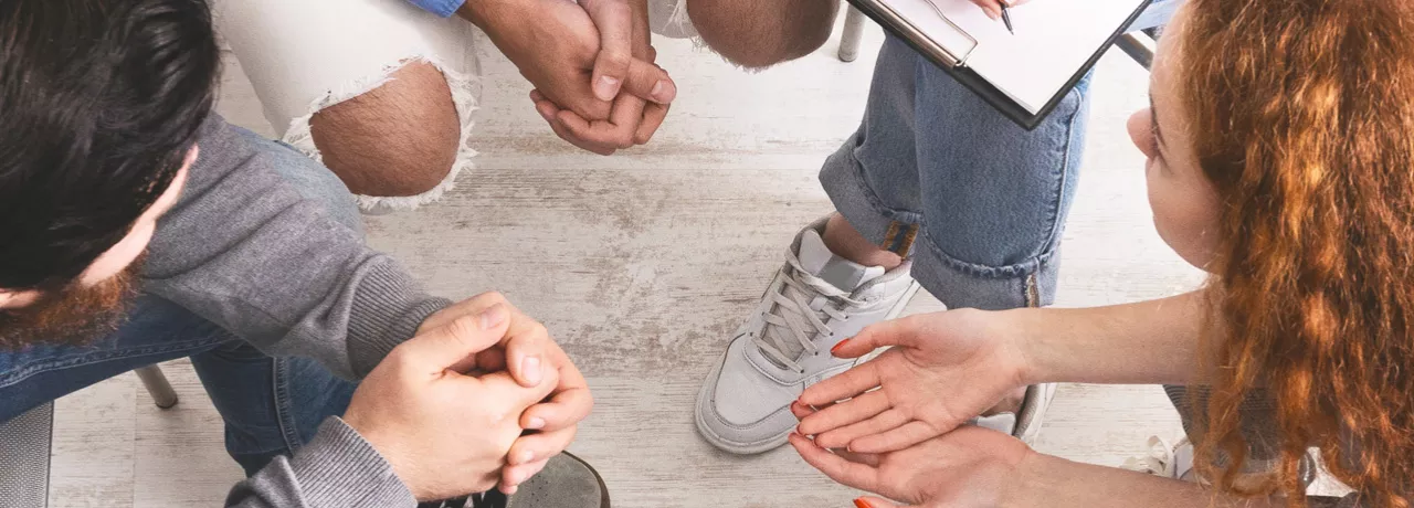 Group of people sitting in a circle talking