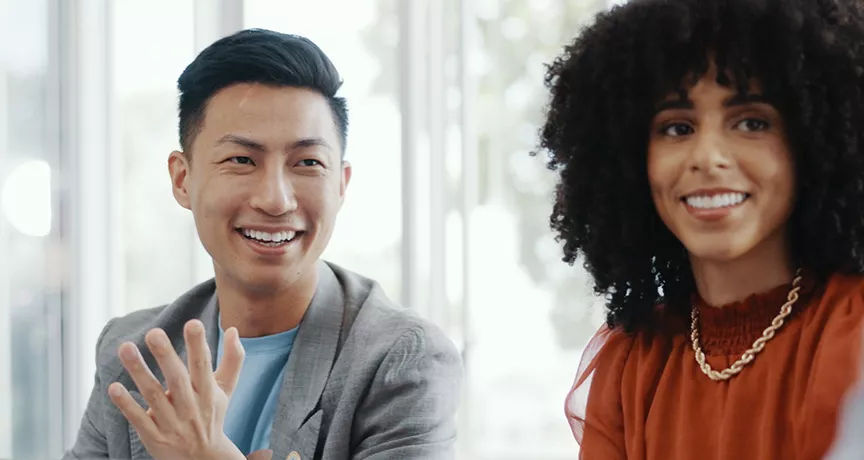 Male and female colleagues looking happy