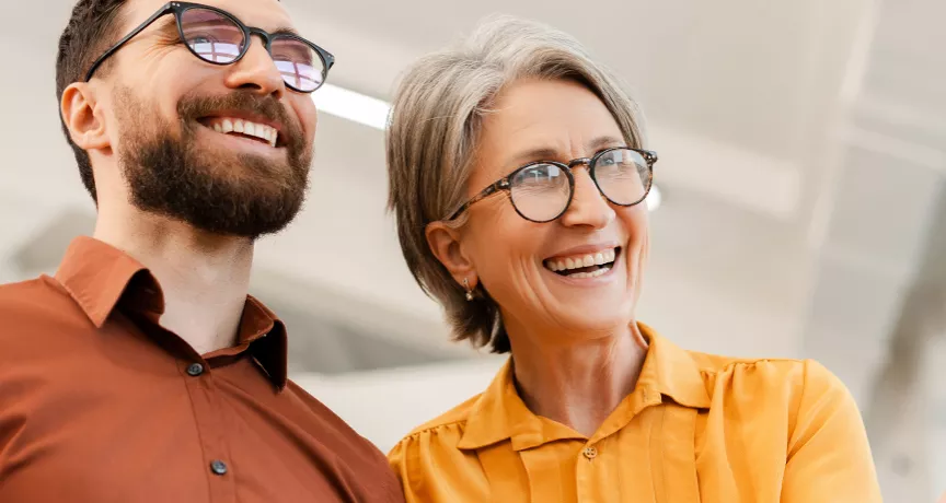 Older man and woman looking smart and smiling