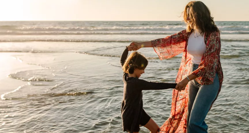 Mother and child playing on the beach