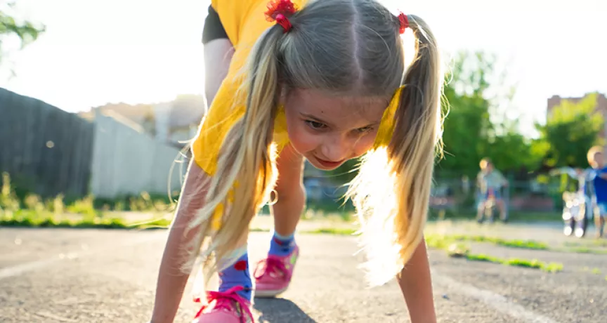 Young girl about to start a running race