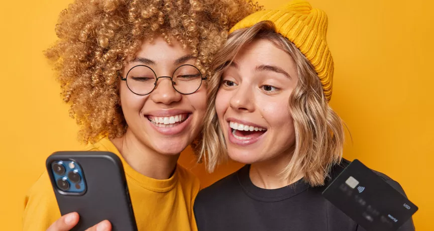 Happy and smiling women holding phone