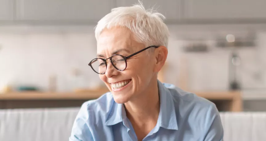 Happy older lady saving some money