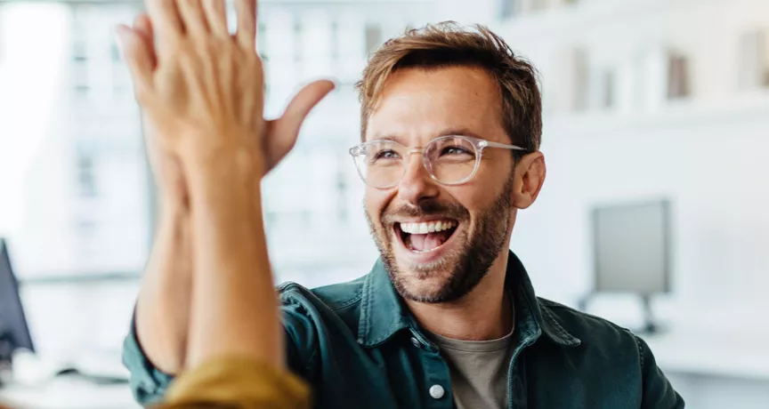 Happy employees giving each other a high five