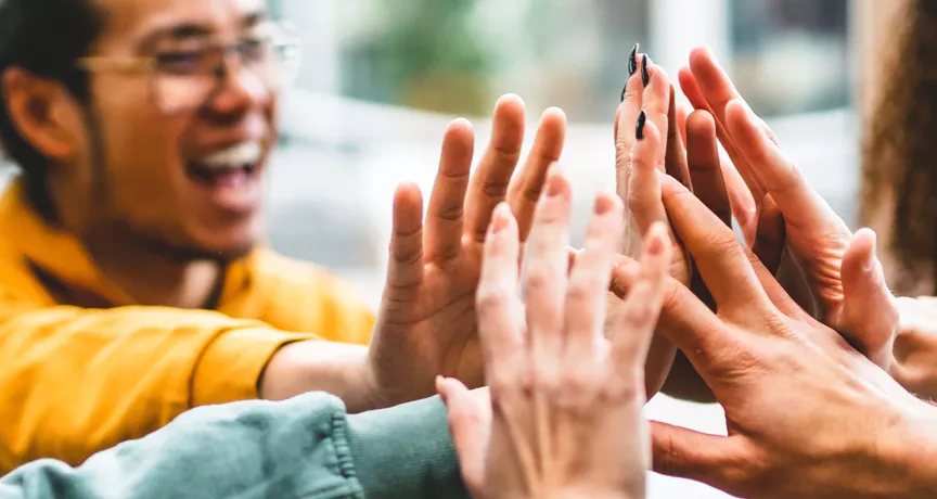 Group of people giving each other a high five