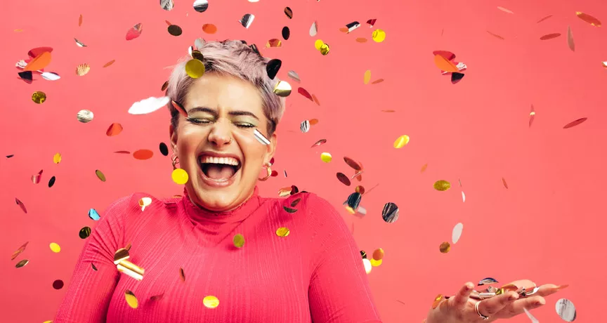 woman celebrating with glitter confetti