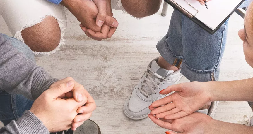 Group of people sitting in a circle talking