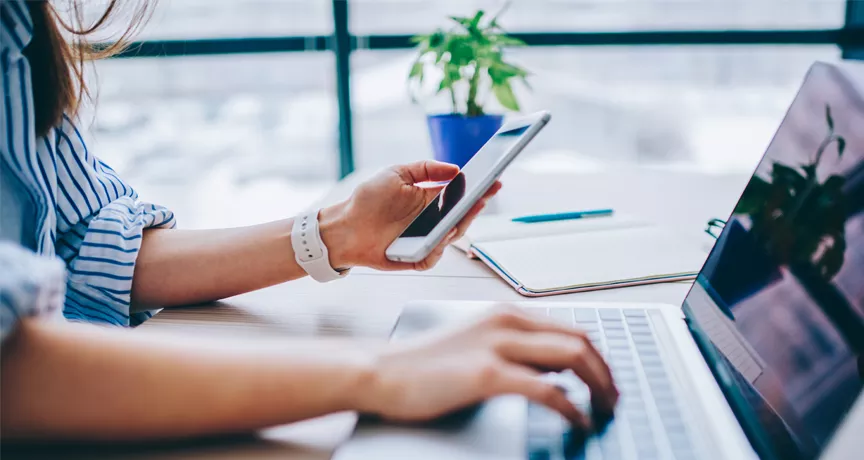 blog upload - woman on phone and laptop