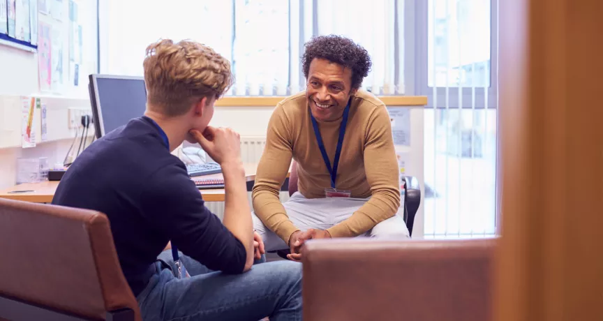 student and teacher having a conversation