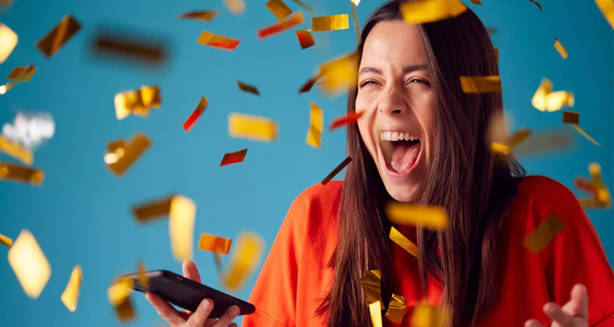 woman celebrating with gold confetti everywhere