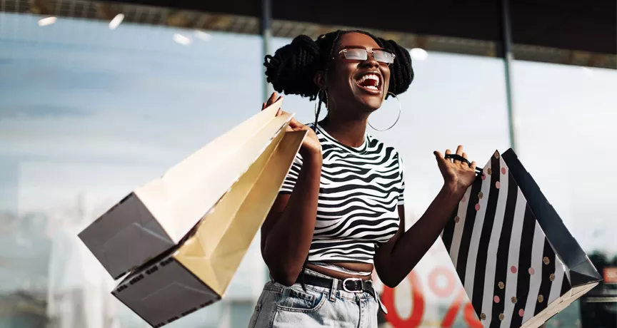 black lady very happy with her shopping bags