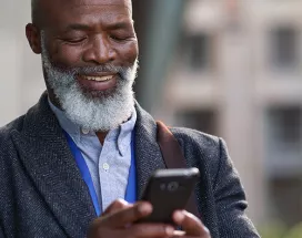 Happy man looking at a digital voucher on phone