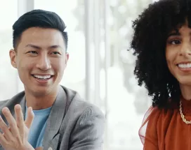Male and female colleagues looking happy