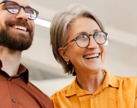 Older man and woman looking smart and smiling