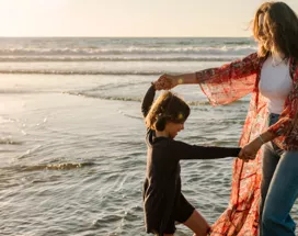 Mother and child playing on the beach