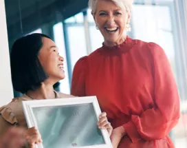 Woman giving a certificate to her colleague