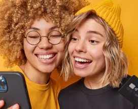 Happy and smiling women holding phone