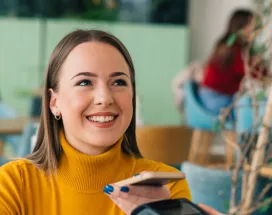 woman paying with phone is cafe