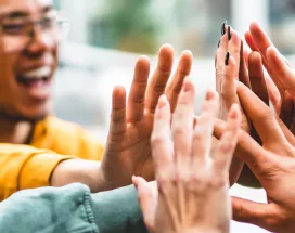 Group of people giving each other a high five