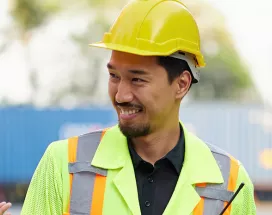 group of people on a construction site clapping their collgeaue