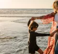 Mother and child playing on the beach