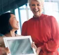 Woman giving a certificate to her colleague