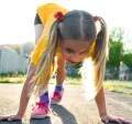 Young girl about to start a running race
