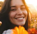 Woman in a field full of tall flowers