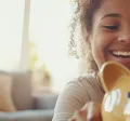 Mum and daughter with a piggy bank for Debt Awareness week Blog