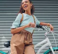 woman leaning against a bike