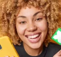 lady smiling and holding her Pluxee Card