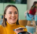 woman paying with phone is cafe