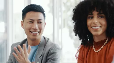 Male and female colleagues looking happy