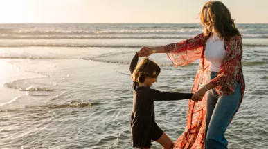 Mother and child playing on the beach