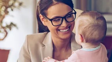 Woman holding a baby while working