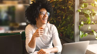 Woman sitting at home working on laptop