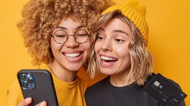 Happy and smiling women holding phone