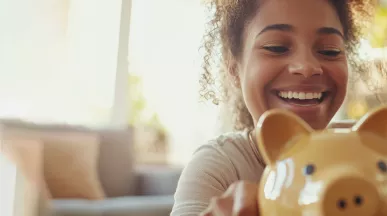 Mum and daughter with a piggy bank for Debt Awareness week Blog